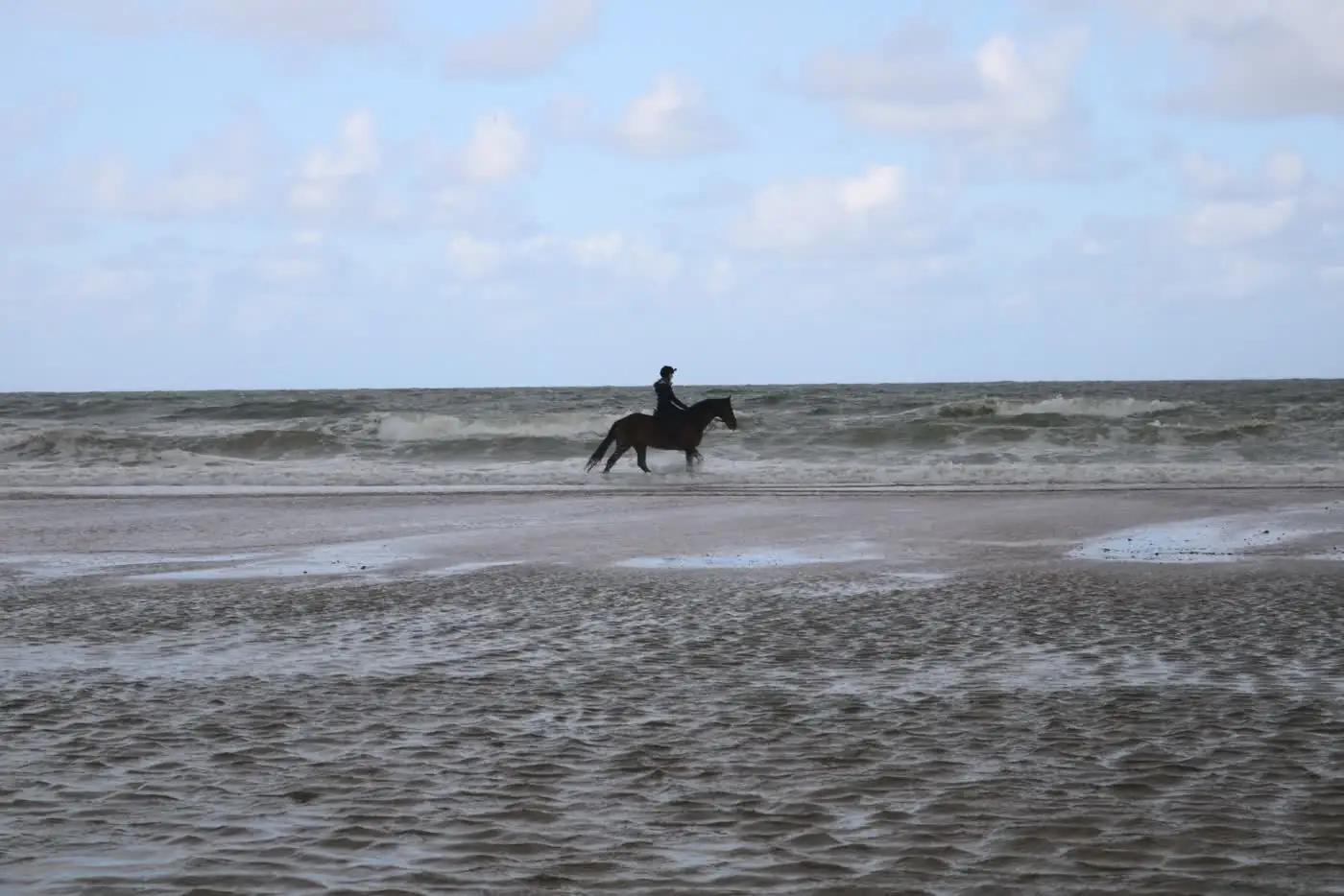 Riding across the sand at low tide