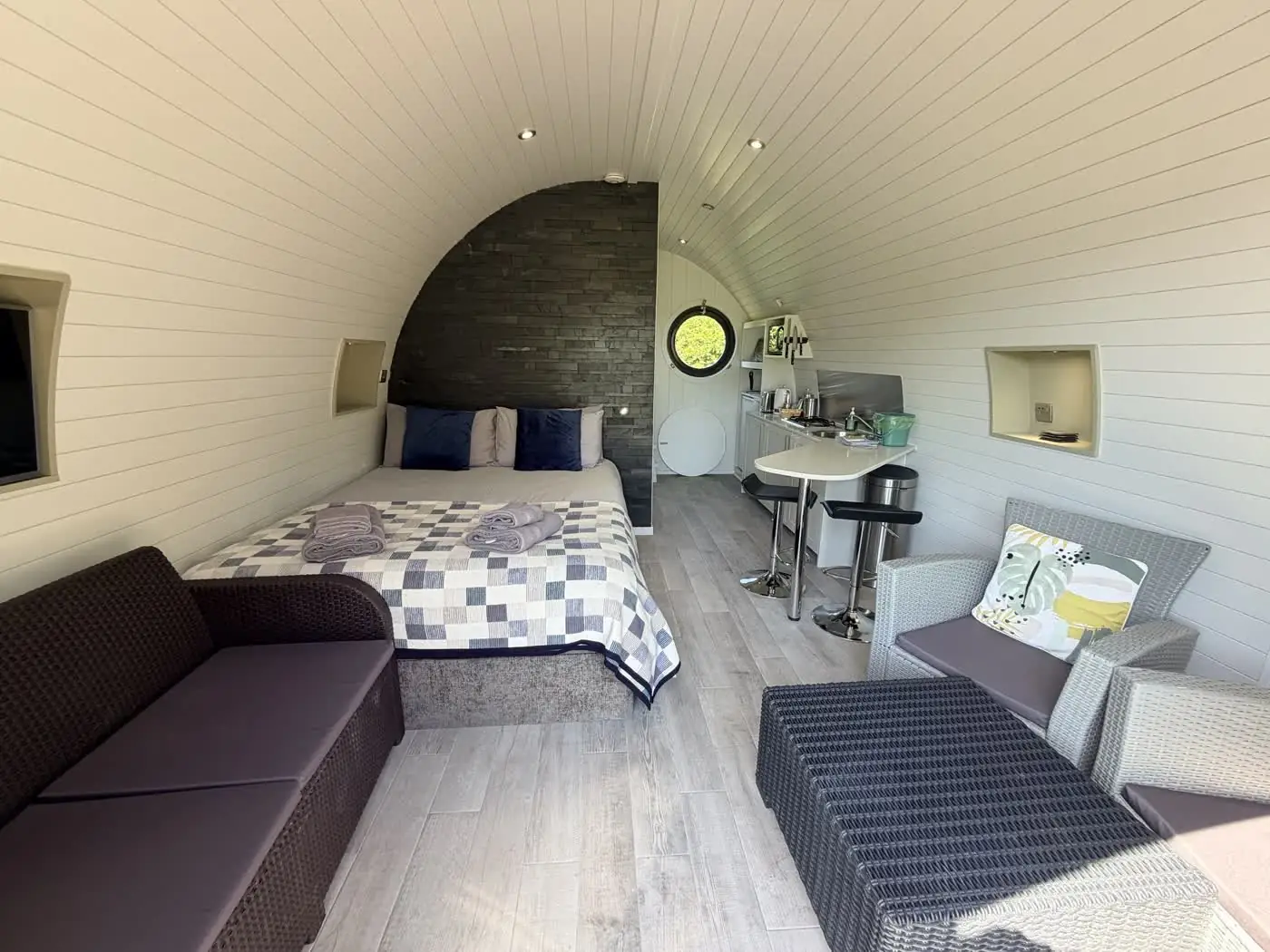 Open-plan living space with kitchen and king bed